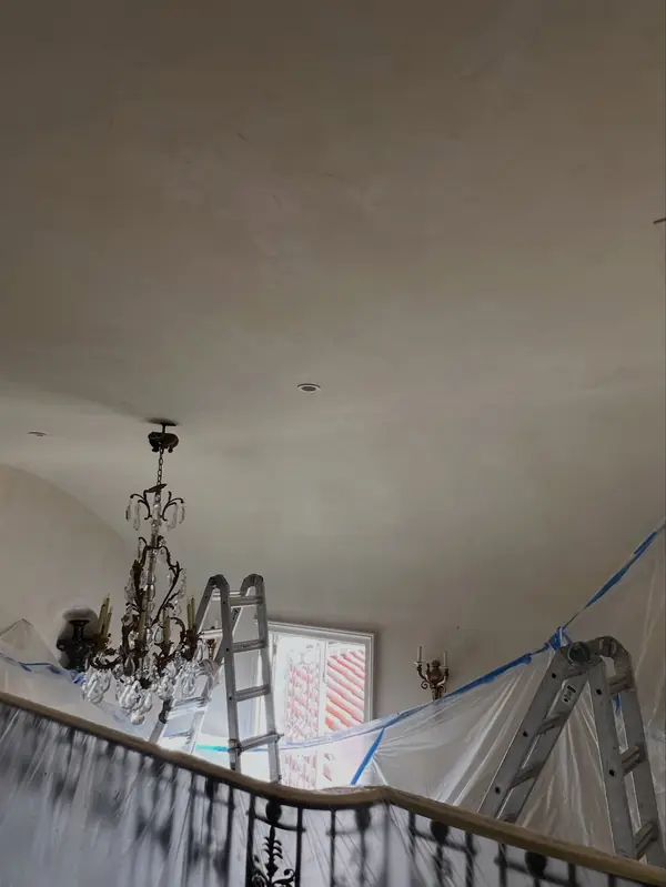Railings, chandelier and floors sealed in plastic before Venetian plaster work on a ceiling in The Avenues, Salt Lake City, Utah