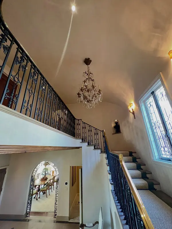 Venetian plaster on the vaulted stairwell ceiling of a Spanish-style residence in The Avenues, Salt Lake City, Utah – hand-applied finish above a crystal chandelier